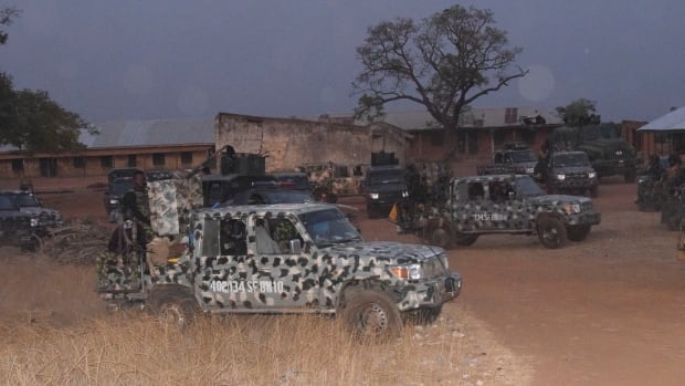 army trucks are seen parked near scene of mass student abduction in northwest nigeria