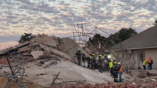 At least 11 people still alive under building collapse rubble, South African officials say