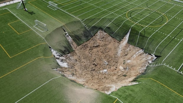 Giant sinkhole swallows part of Illinois soccer field where children often play