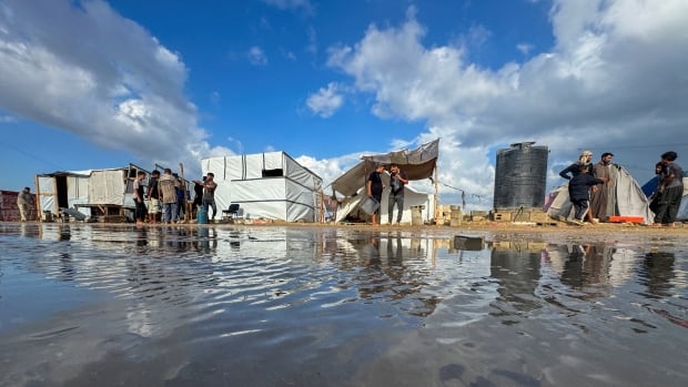 Israeli airstrikes hit Gaza as heavy rains flood camps for displaced Palestinians