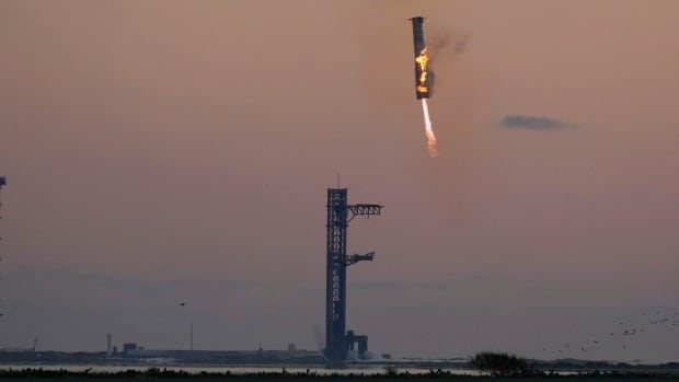 Launch tower's 'chopsticks' catch descending rocket booster as SpaceX launches Starship