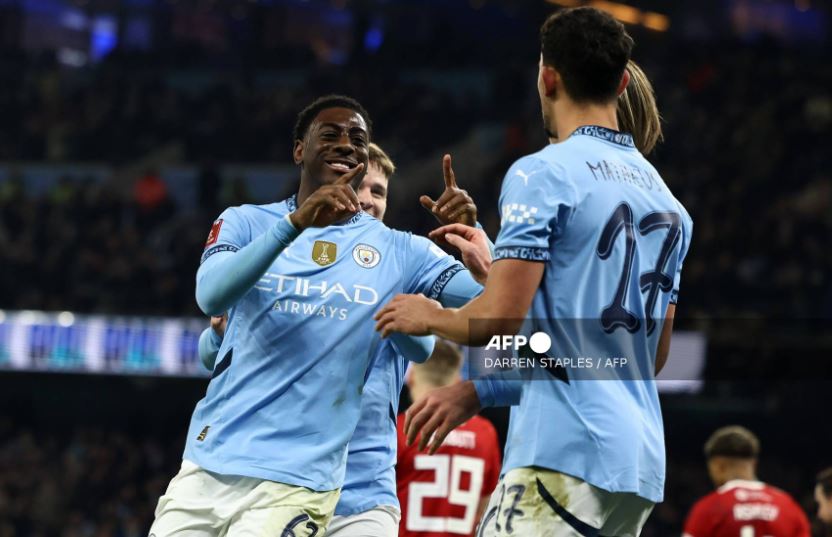 Manchester City’s English striker #67 Divin Mubama (L) celebrates scoring the team’s second goal with Manchester City’s Portuguese midfielder #27 Matheus Nunes during the English FA Cup third round football match between Manchester City and Salford City at the Etihad Stadium in Manchester, north west England, on January 11, 2025